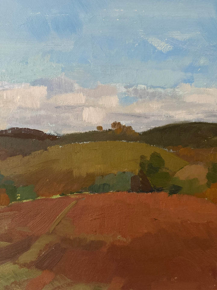 An impressionistic landscape painting featuring rolling hills with a prominent reddish-brown foreground, green and olive fields, dark tree lines, and a blue sky with white clouds.