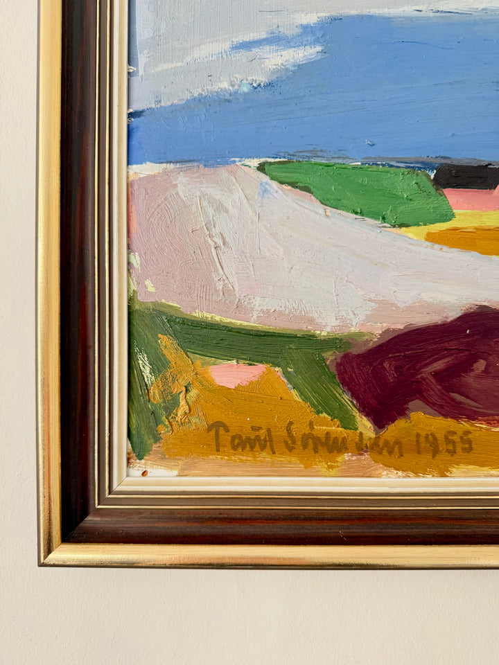 A close-up of a framed abstract landscape painting on a light beige wall. The artwork features thick brushstrokes of blue sky, pale pink, green, yellow, and dark red shapes, with a visible signature reading 'Paul Serre 1955' near the bottom.