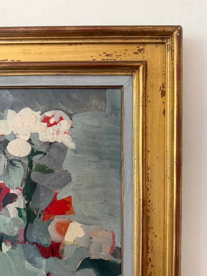 Close-up of a framed painting showing an abstract floral scene with white and red flowers against a gray background, set in a distressed gold frame.